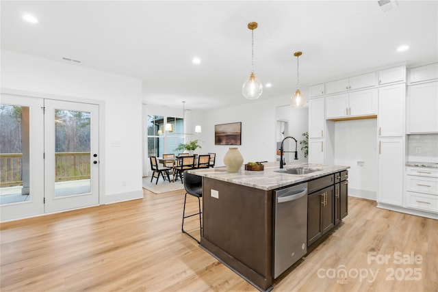 5147 Star Magnolia Ct, Clover, SC 29710 - kitchen with white cabinetry, light wood-style flooring, a sink, and dishwasher