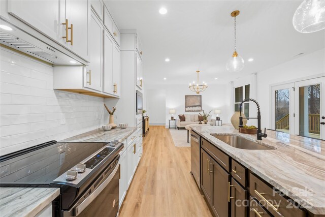 5147 Star Magnolia Ct, Clover, SC 29710 - kitchen featuring a sink, white cabinetry, stainless steel dishwasher, under cabinet range hood, and electric range