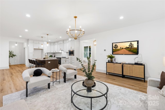 5147 Star Magnolia Ct, Clover, SC 29710 - living area featuring light wood-style flooring, a notable chandelier, baseboards, and recessed lighting
