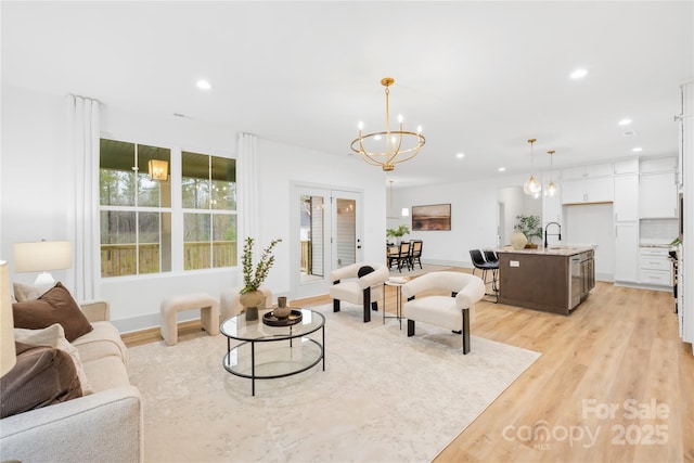 5147 Star Magnolia Ct, Clover, SC 29710 - living area featuring baseboards, light wood-style flooring, recessed lighting, and an inviting chandelier