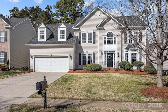 view of front facade featuring a front yard and a garage