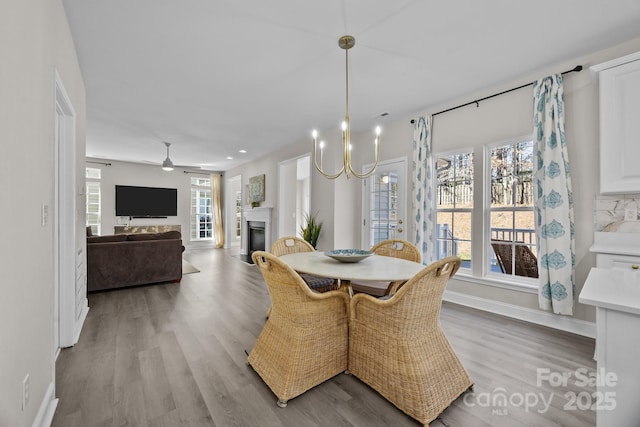 dining area with a healthy amount of sunlight, ceiling fan, and light wood-type flooring