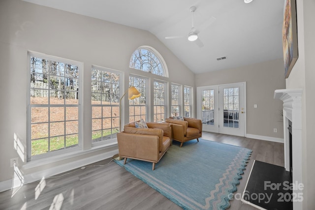 living room featuring ceiling fan, high vaulted ceiling, and hardwood / wood-style floors