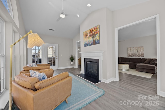 living room featuring ceiling fan, high vaulted ceiling, and hardwood / wood-style floors