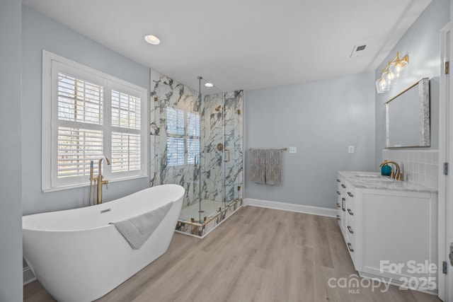 bathroom featuring hardwood / wood-style flooring, vanity, and independent shower and bath