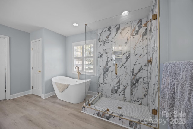 bathroom featuring separate shower and tub and hardwood / wood-style flooring