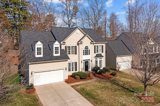 view of front of property featuring a front lawn and a garage