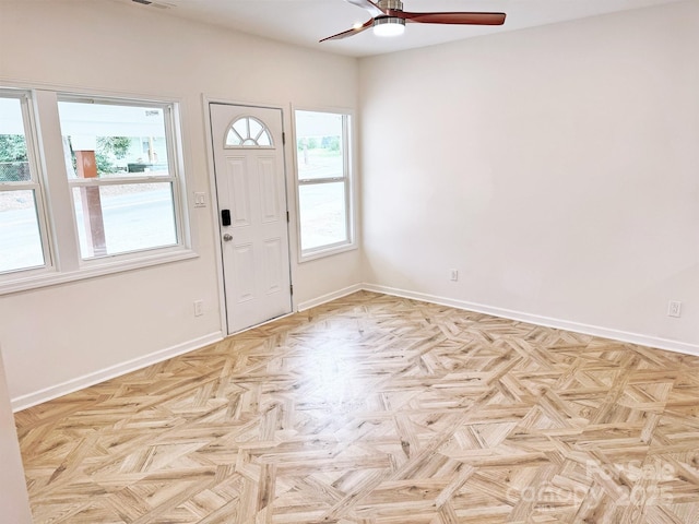 entrance foyer featuring visible vents, a ceiling fan, and baseboards