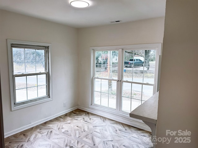 empty room with baseboards and visible vents