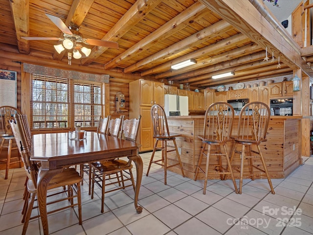 dining space featuring light tile patterned floors, wood ceiling, and beamed ceiling