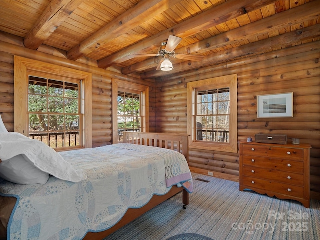 bedroom with beam ceiling, log walls, and wood ceiling