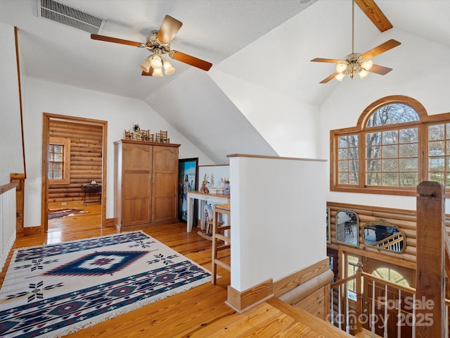 bonus room with high vaulted ceiling, light wood finished floors, visible vents, and a ceiling fan