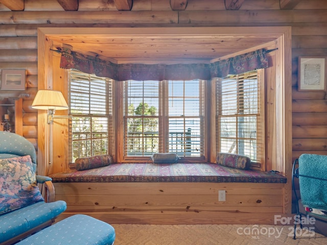 living area featuring log walls