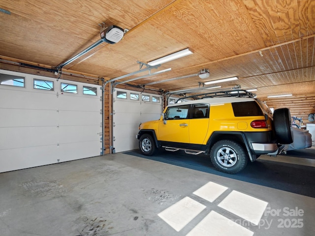 garage with wood ceiling and a garage door opener