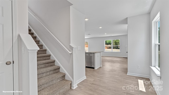 stairs with hardwood / wood-style flooring