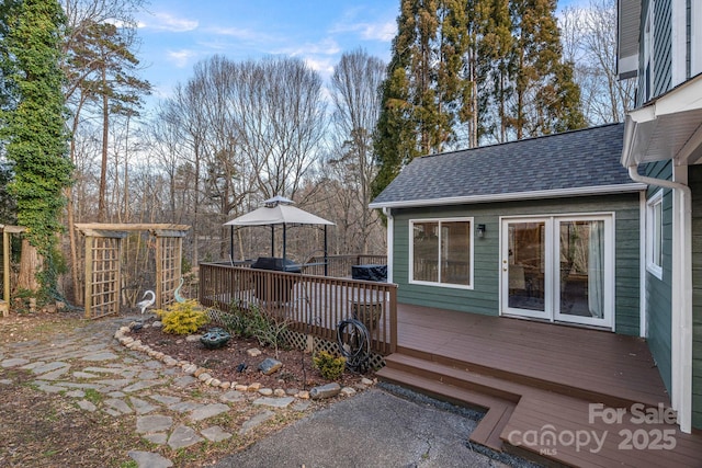 wooden terrace featuring a gazebo