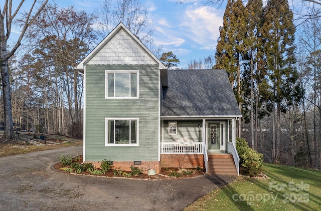 view of front of home with crawl space, aphalt driveway, and roof with shingles