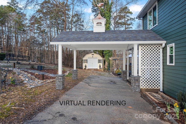 view of vehicle parking with a shed and a carport