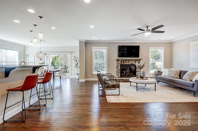 living room featuring ceiling fan, dark wood-type flooring, and ornamental molding