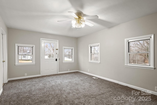 spare room with carpet flooring and ceiling fan