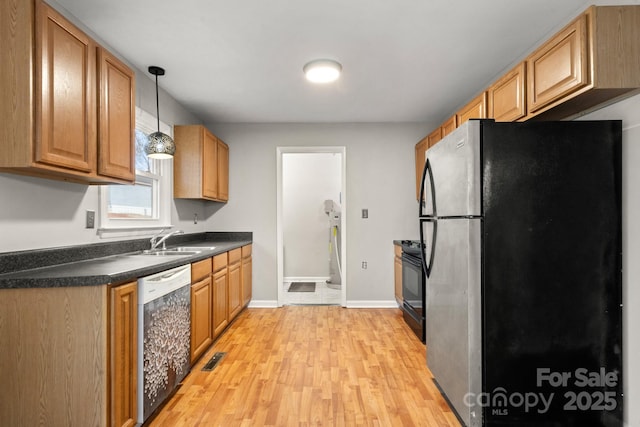 kitchen featuring sink, dishwasher, decorative light fixtures, black electric range oven, and stainless steel fridge