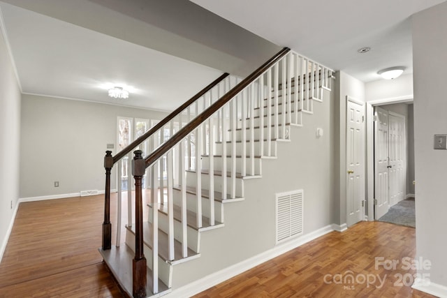 stairs with hardwood / wood-style floors