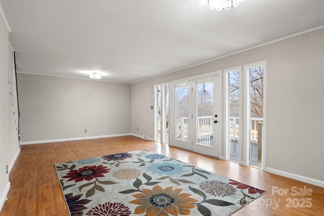 interior space with crown molding and wood-type flooring