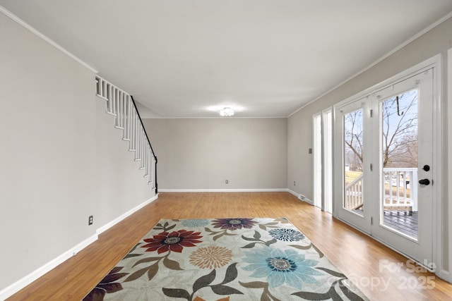 living room with light wood-type flooring and ornamental molding