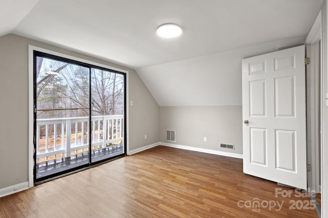 bonus room featuring hardwood / wood-style flooring and lofted ceiling