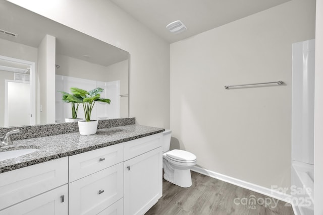 full bathroom with visible vents, vanity, toilet, and wood finished floors