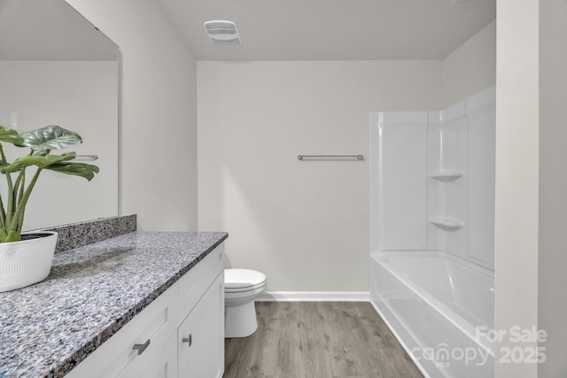 full bath featuring baseboards, visible vents, toilet, wood finished floors, and vanity