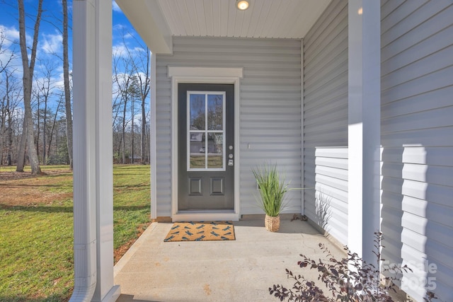 property entrance with a yard