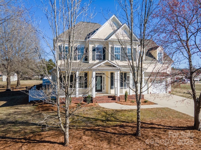 colonial-style house with a front yard and a garage