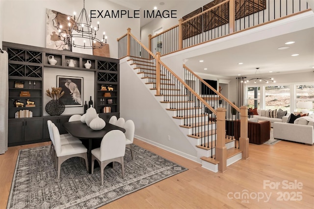 11016 Tyler Brook Ln Unit Oak0036, Mint Hill, NC 28227 - dining area featuring a chandelier, wood finished floors, stairs, a towering ceiling, and recessed lighting