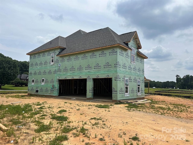 11016 Tyler Brook Ln Unit Oak0036, Mint Hill, NC 28227 - view of property exterior featuring dirt driveway, a garage, and roof with shingles
