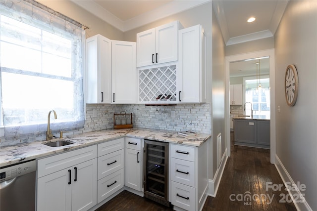 kitchen featuring sink, beverage cooler, white cabinetry, dishwasher, and decorative backsplash