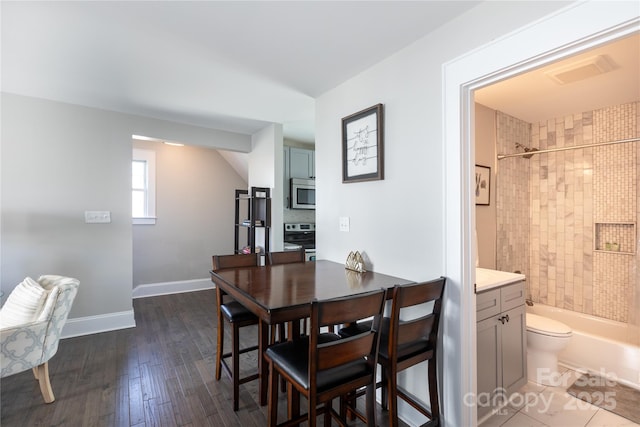 dining space featuring dark hardwood / wood-style floors