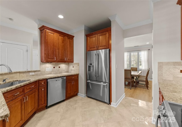 kitchen with sink, backsplash, stainless steel appliances, light stone counters, and ornamental molding