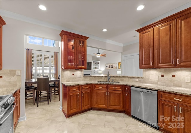 kitchen with stainless steel appliances, crown molding, light stone countertops, and sink