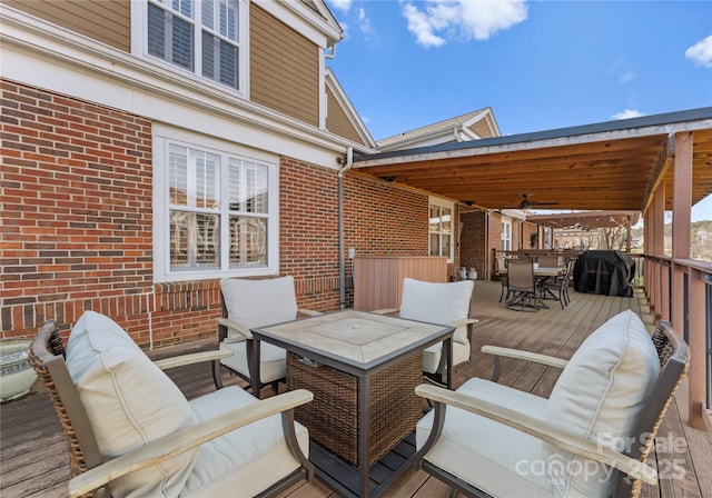 deck featuring area for grilling and an outdoor living space with a fire pit