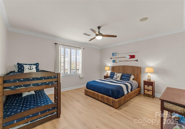 bedroom with hardwood / wood-style floors, ornamental molding, and ceiling fan