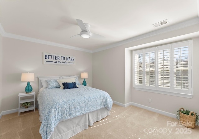 bedroom featuring crown molding, light colored carpet, and ceiling fan