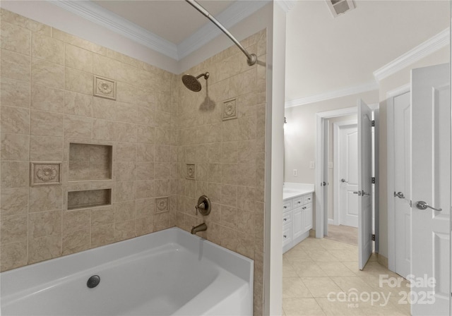 bathroom featuring vanity, tile patterned floors, crown molding, and tiled shower / bath