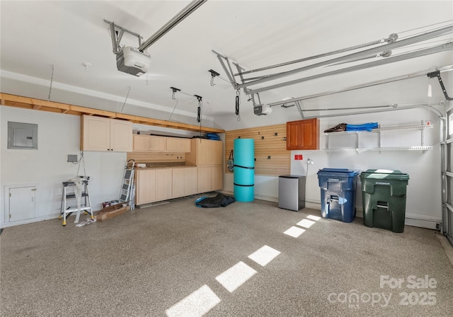 garage featuring a garage door opener and electric panel