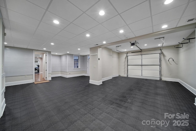 garage featuring baseboards, visible vents, and recessed lighting