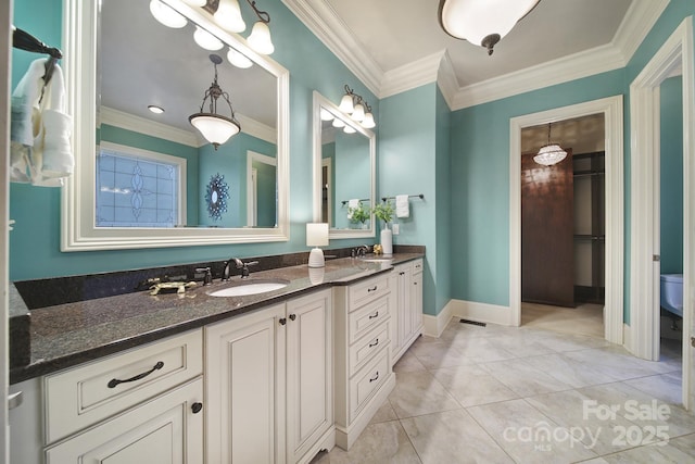full bathroom featuring baseboards, double vanity, a sink, and crown molding