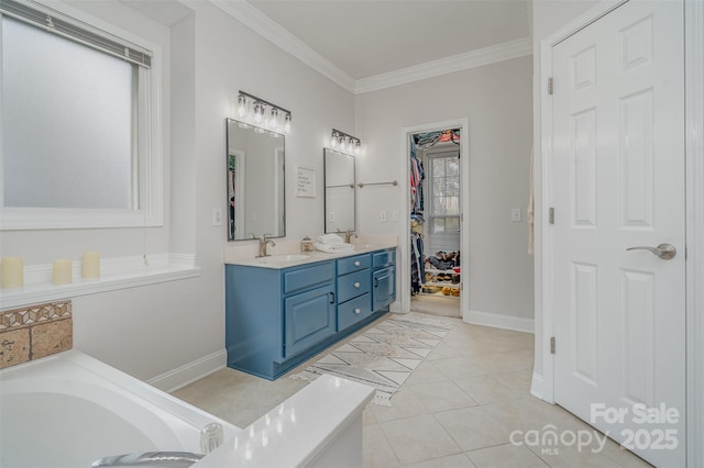 bathroom with a tub, tile patterned floors, crown molding, and vanity