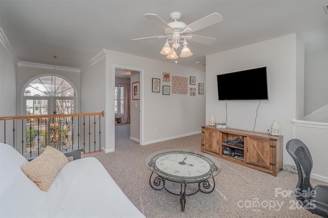 carpeted living room featuring ceiling fan and ornamental molding