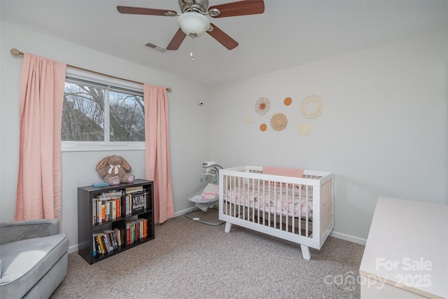 bedroom with carpet, ceiling fan, and a nursery area