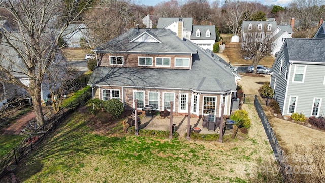 rear view of property featuring a patio area and a yard